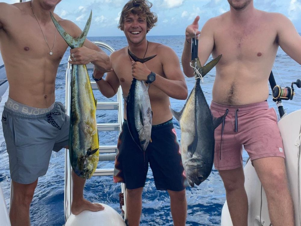 Three anglers with mahi-mahi and tuna aboard the boat off Bonaire