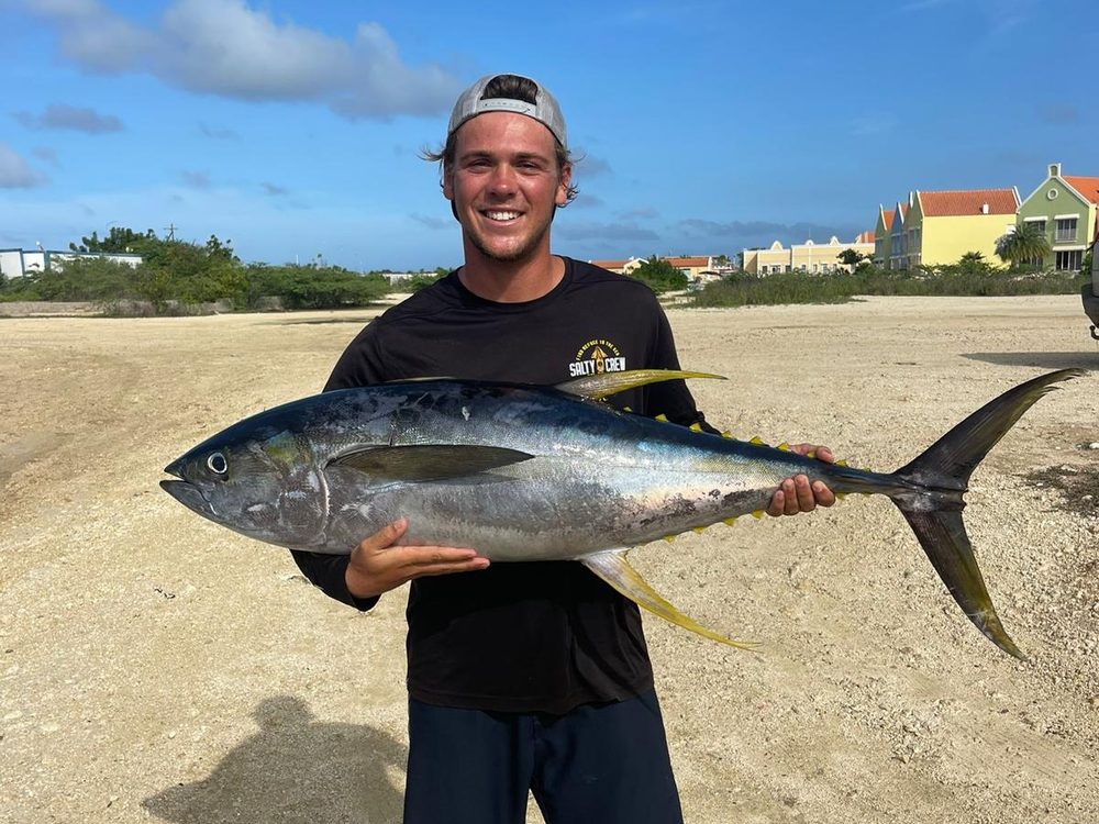 Angler with a large yellowfin tuna on the beach at Bonaire